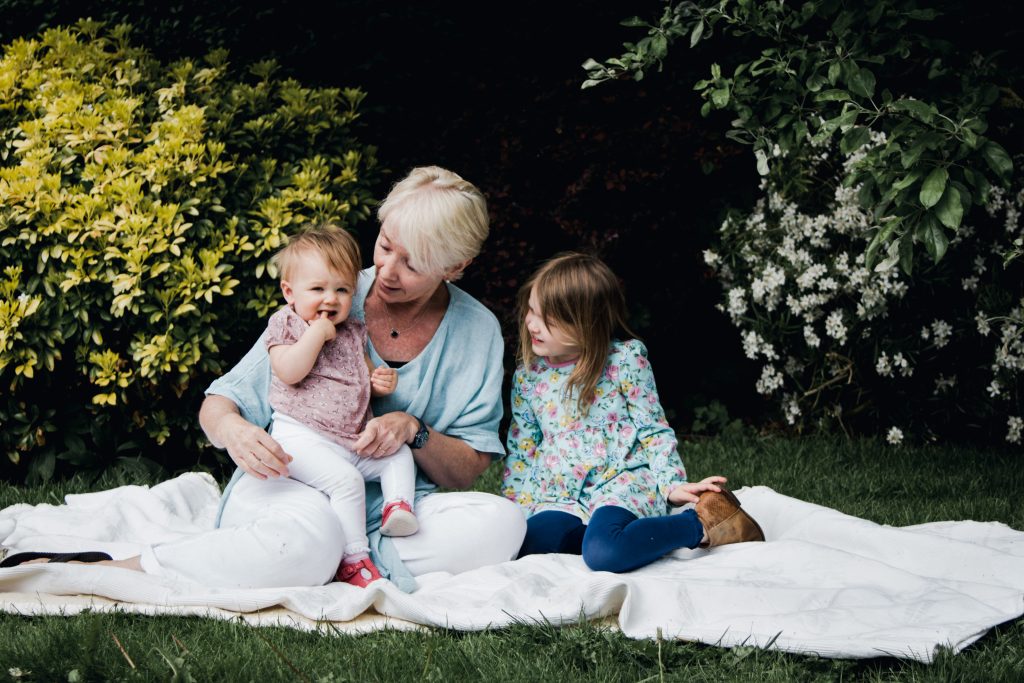 Grandmother in the garden with granddaughters