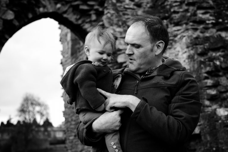 Black and white image of Dad, Daughter and Grandad outside