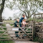 Father and children by a farm gate in swaledale