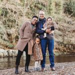 Autumn family portrait standing by a river