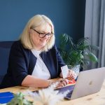 Female business owner chatting to a client via video call on her laptop