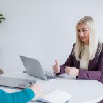 Working portrait of a business women having a meeting with a client at a desk.