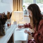 Female artist sketching in her home studio.