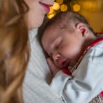 Close up of a newborn baby being held by Mum