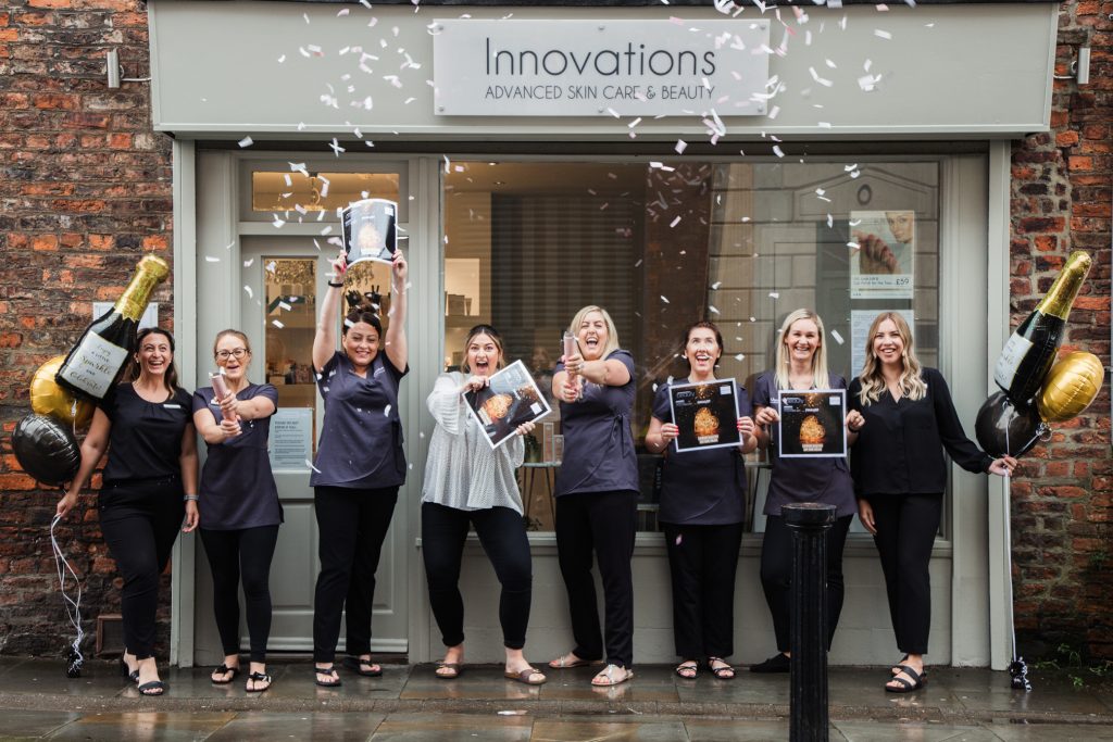 Photo of Innovations Skincare staff celebrating winning an award.