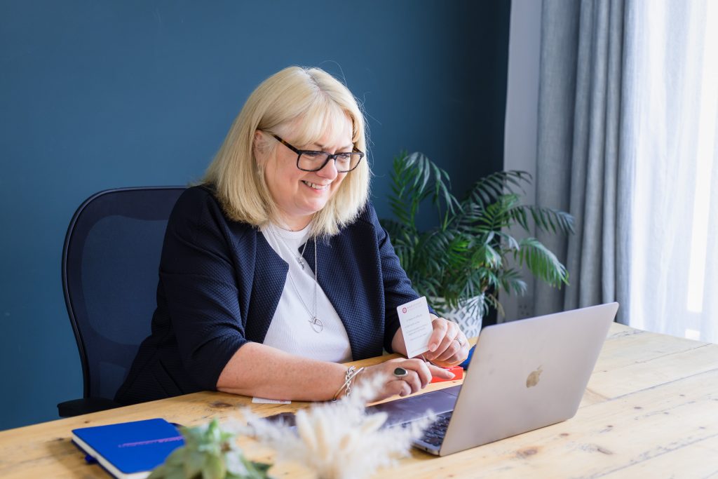 Female business owner chatting to a client via video call on her laptop