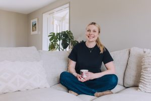 The HAUS owner sitting on the lounge sofa
